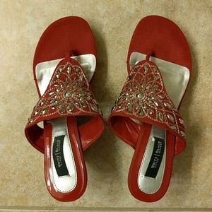 Red wedge sandals with silver colored rhinestones